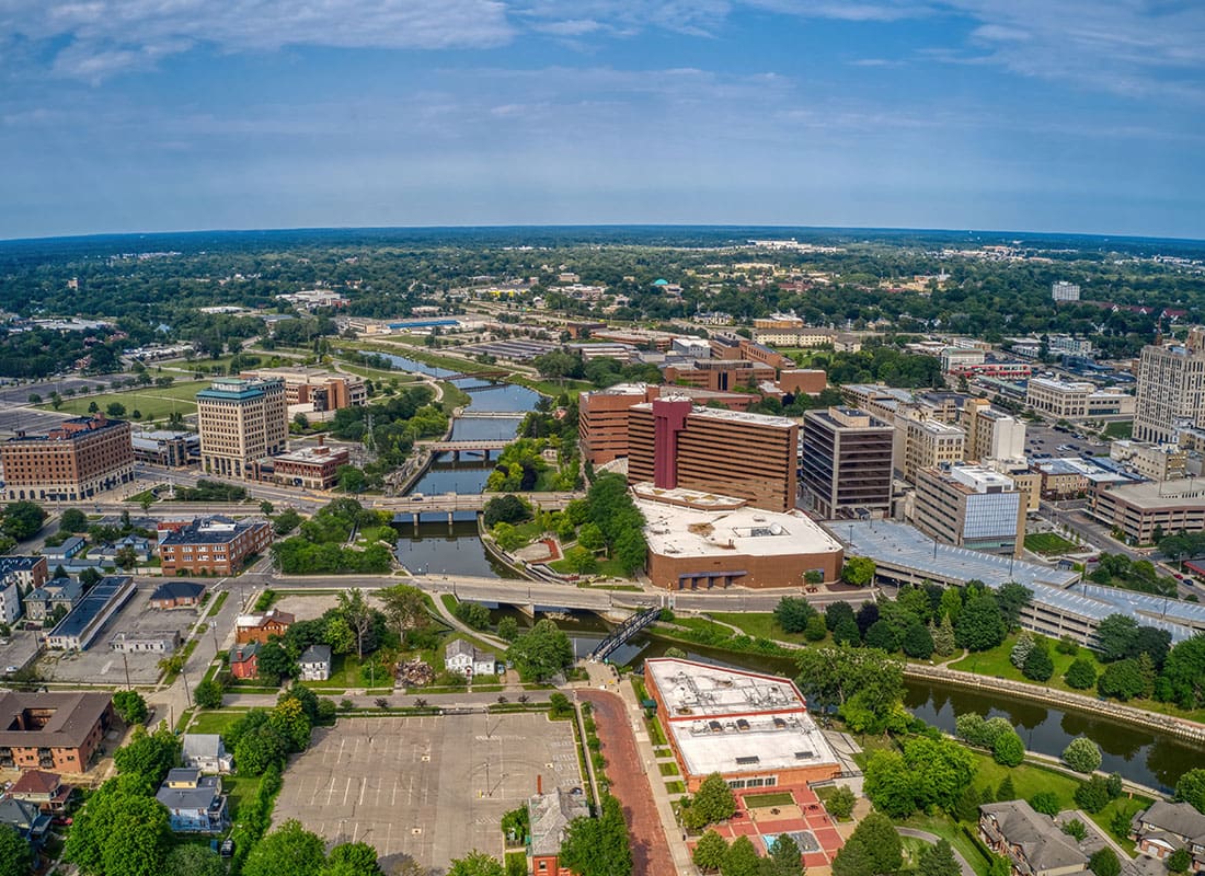 Flint, MI - Aerial View of Buildings Surrounded by Green Foliage on a Summer Day in Flint Michigan